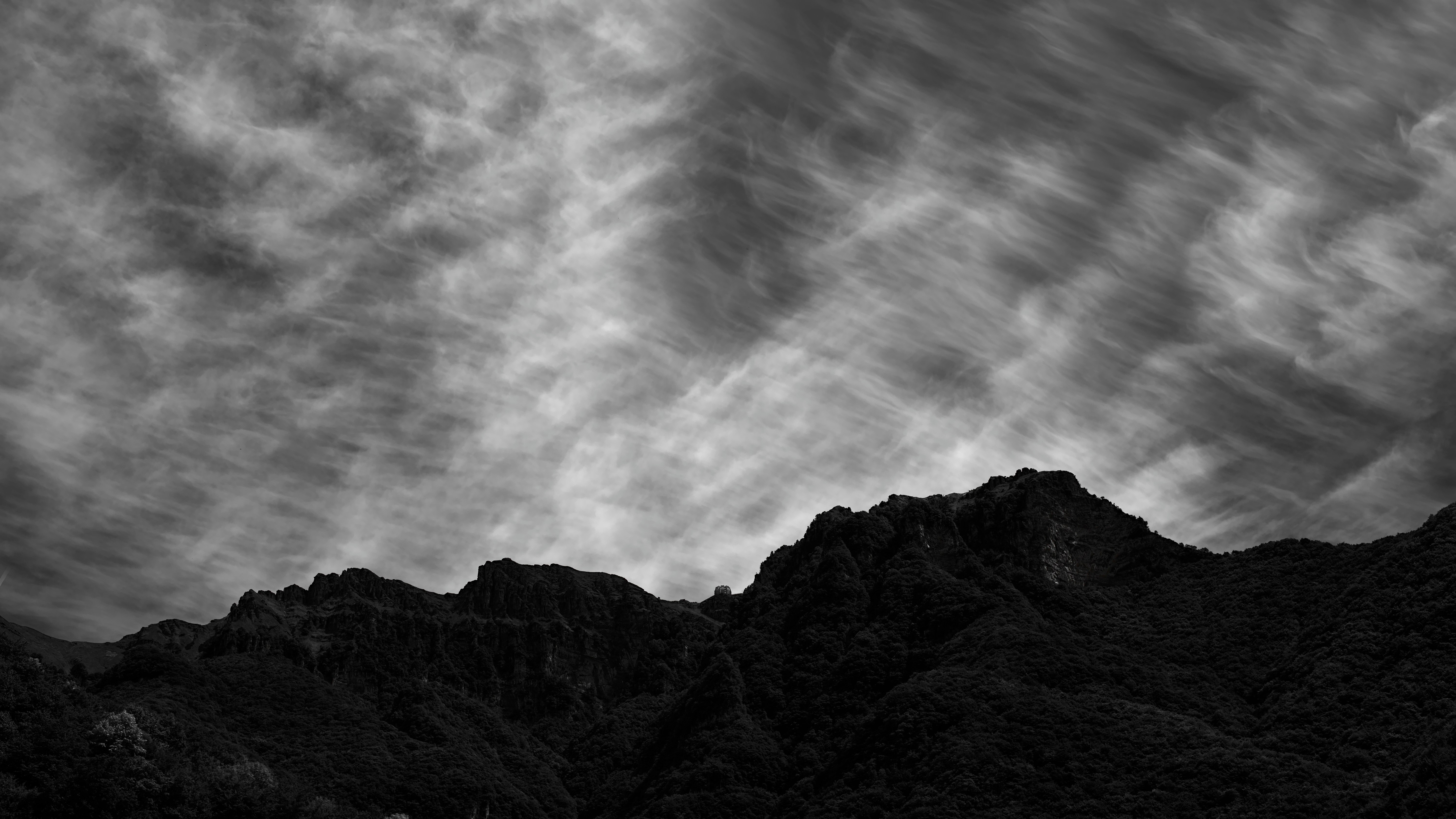 gray and black mountain under gray clouds